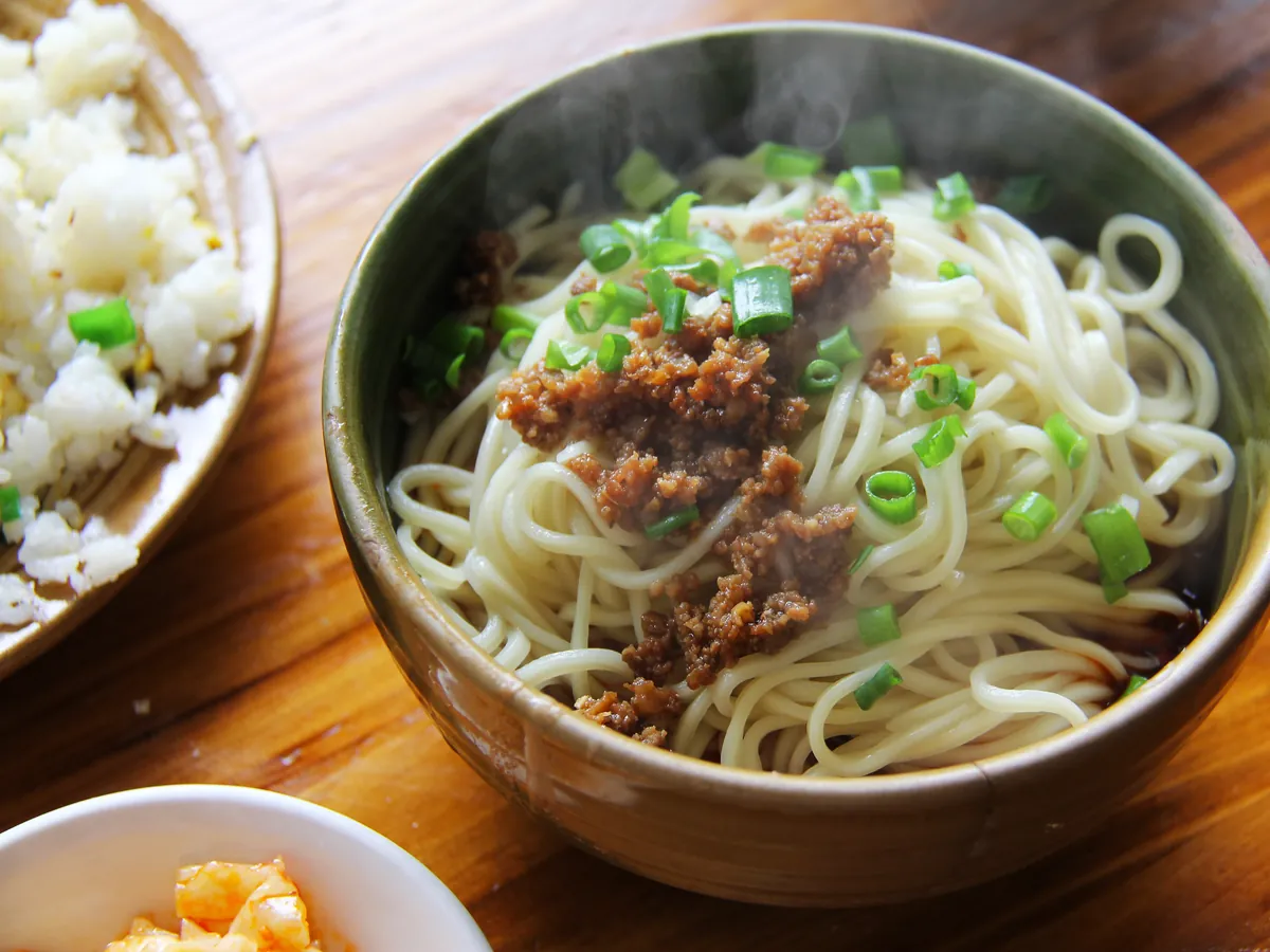 Dan Dan noodles topped with peanuts and scallions