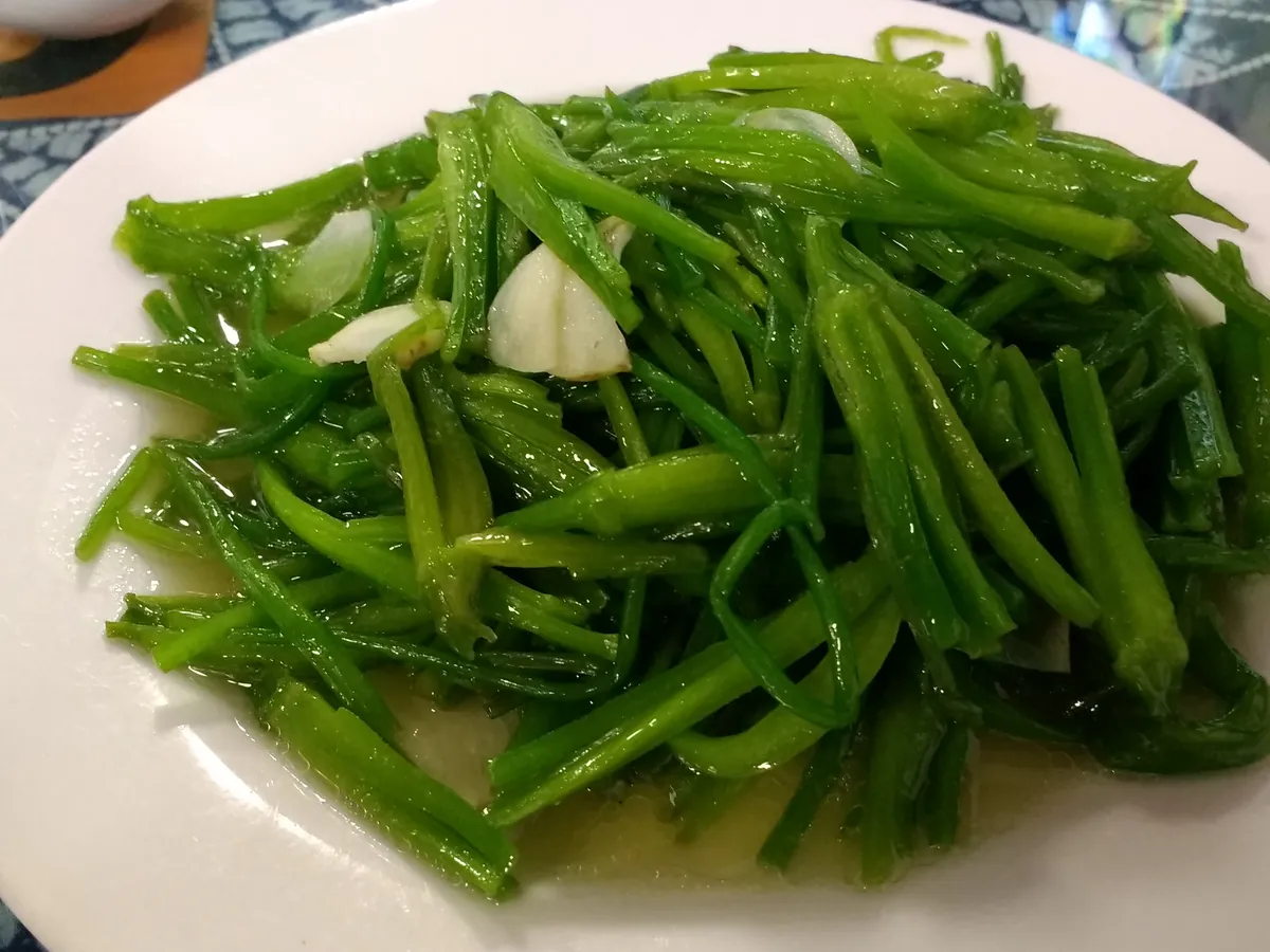 Cooked aquatic greens served at a restaurant in Dali