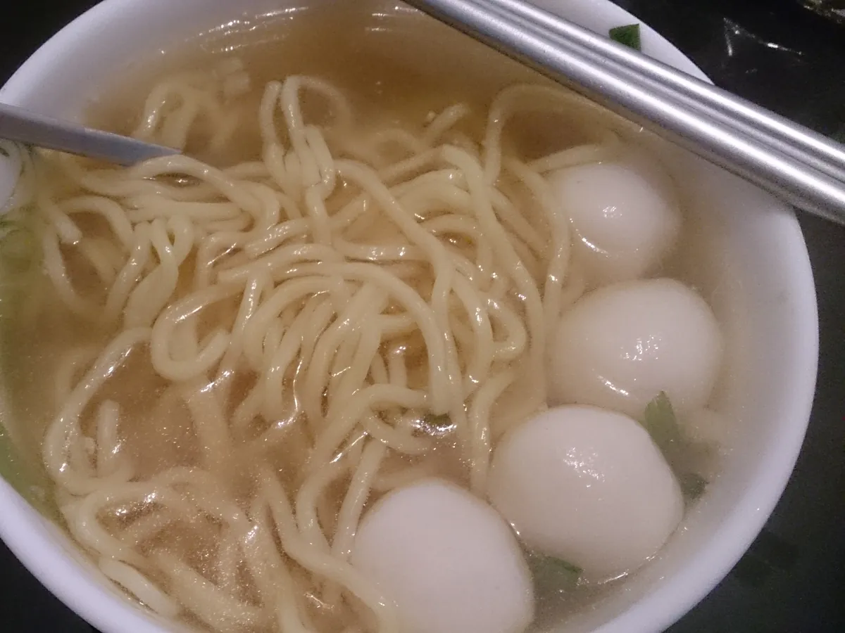 Springy fish balls served in a clear soup with noodles
