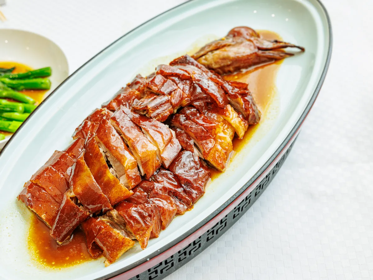 Sliced Cantonese roast goose on a serving plate