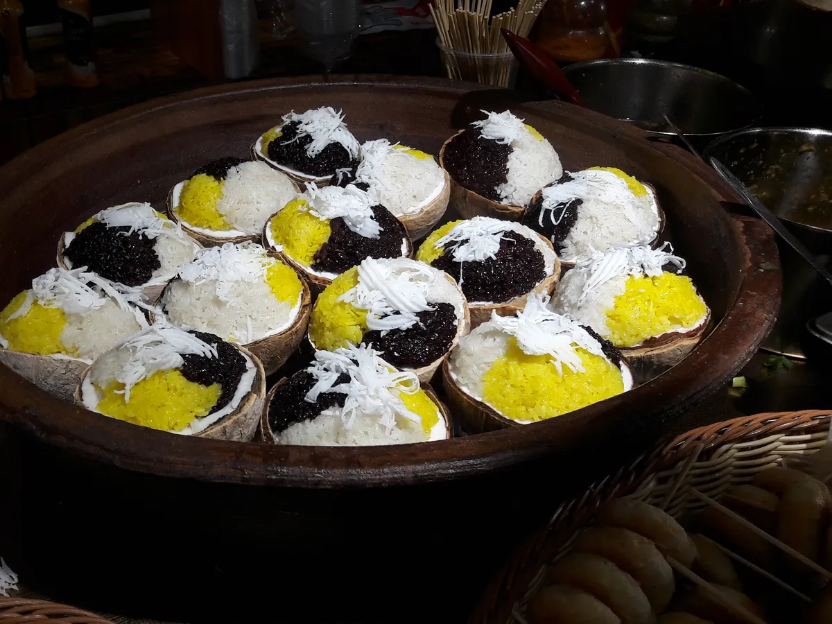 Hainan coconut rice steamed and served in a coconut shell
