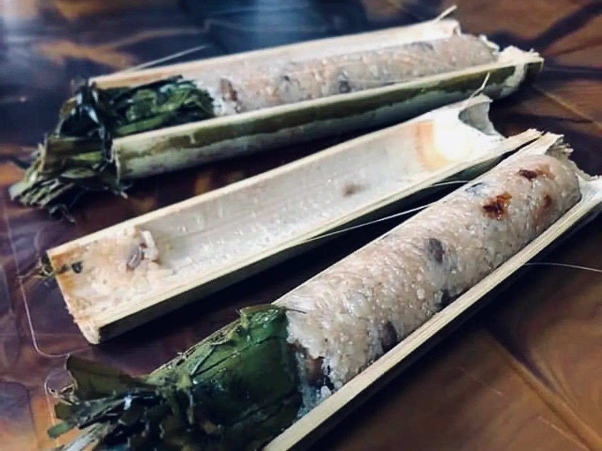Bamboo tubes opened to reveal steamed rice