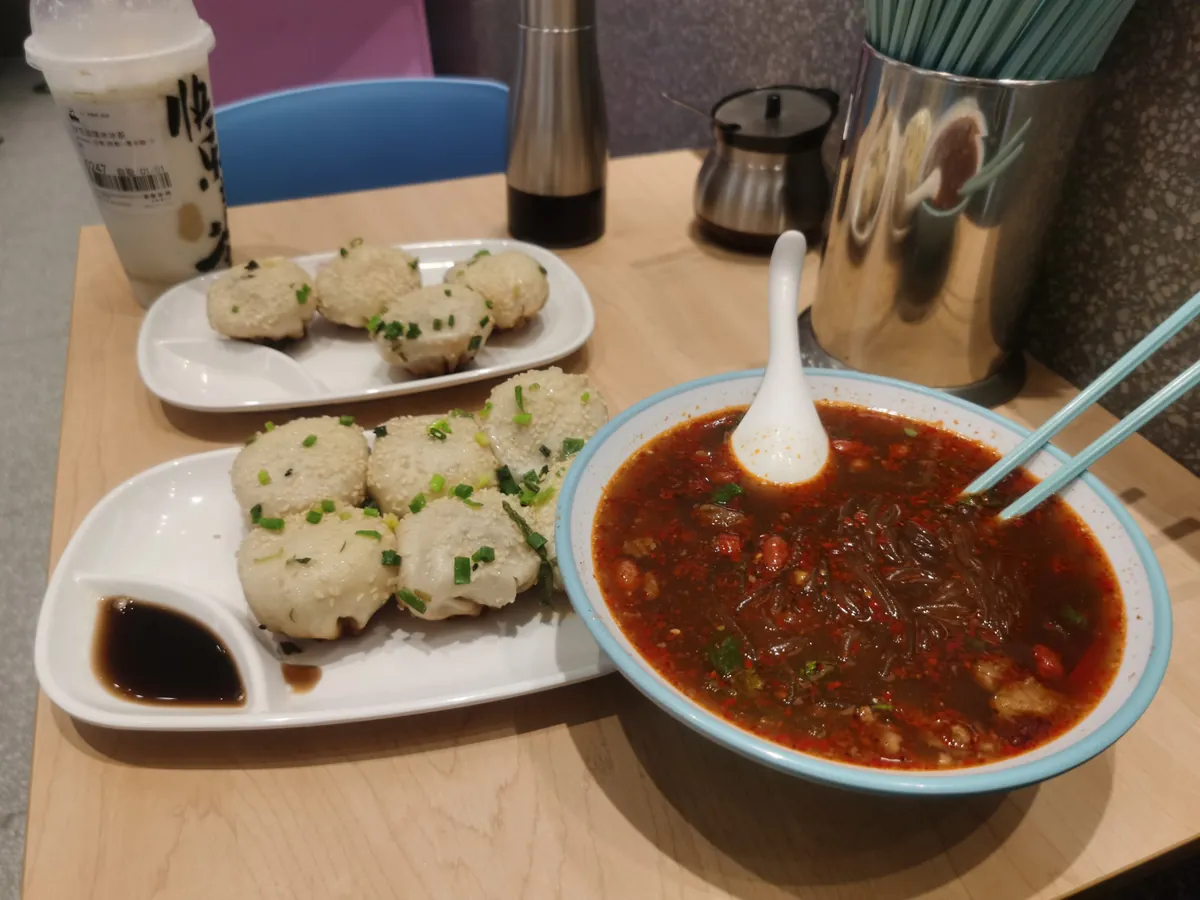 Suzhou shengjian buns with crisp bottoms, sesame, and scallion
